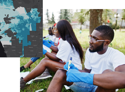 Young Black people sitting outdoors working on a community project