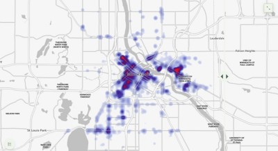 A rey base map of the city of Minneapolis with purple and orange heat clusters spread throughout 