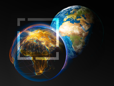 Graphic of two identical planet Earths, one with Europe, Asia, and Africa lit for daytime by the sun, the other dark and lit by a bright interconnected web of light