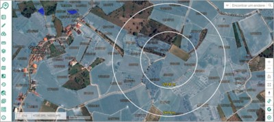 Aerial map depicts agricultural land, featuring two concentric circles centered around a small village