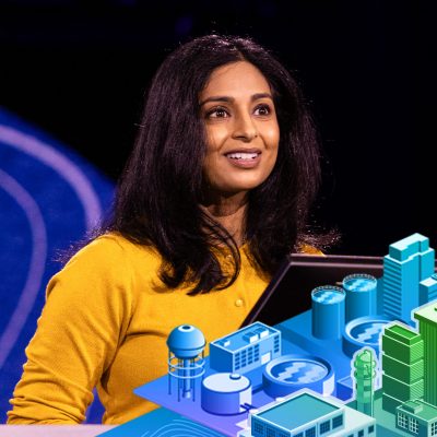 Smiling person with long dark hair and a gold top looks to the right with a 3D city modle below and to to the right