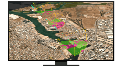 A graphic of a computer monitor displaying an aerial photo of a desert city with segments shaded in green and pink