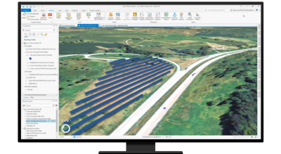 A desktop computer displaying a map in ArcGIS software with added blue lines indicating digital placements of solar panels
