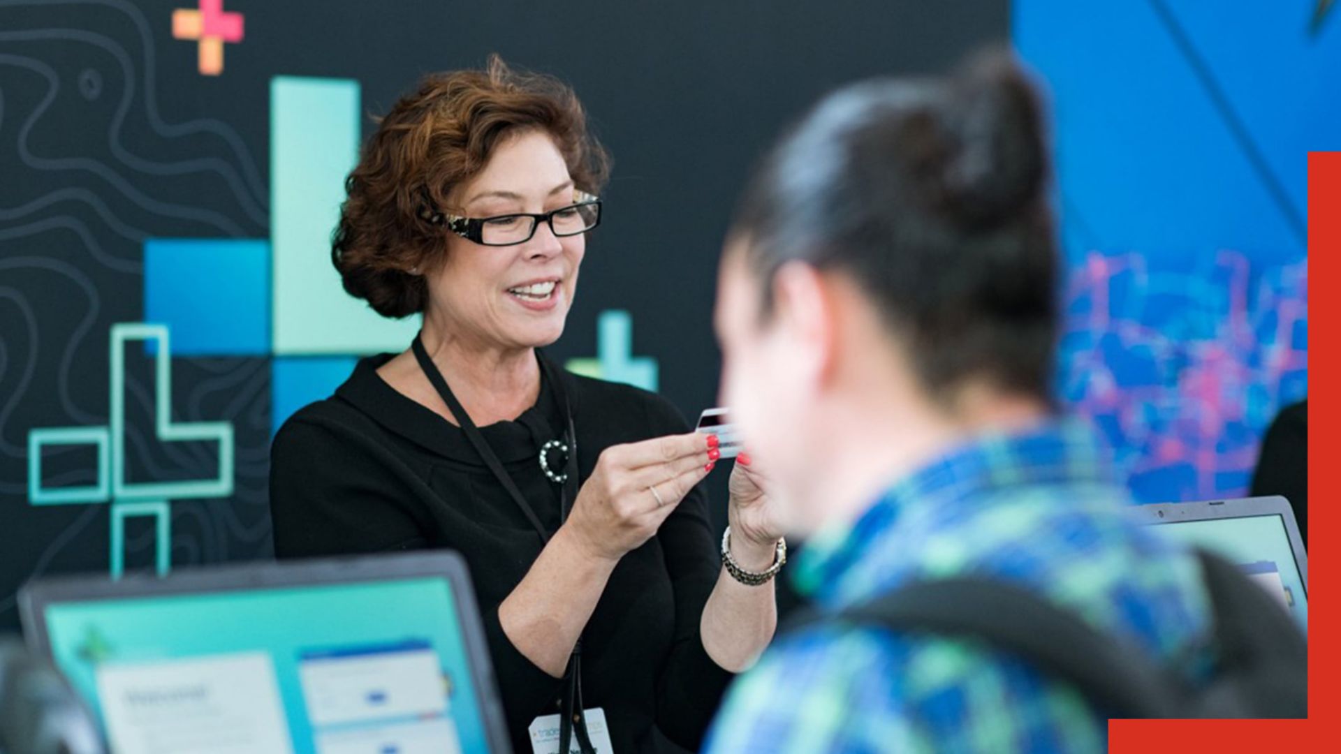 Person holding up an ID while checking in a conference attendee