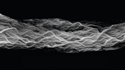 Abstract grayscale visualization of layered wave-like patterns on a dark background