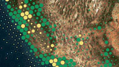 A satellite view of a rugged, desert-like terrain is overlaid with colorful circular data points.