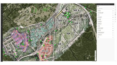 Map of development areas, parcel boundaries, and permit locations over aerial imagery with labeled zones