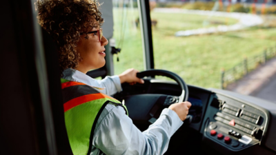 Side view of a person driving a bus