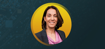 Portrait of Kendra Rodgers McGraw smiling in a pink shirt and dark blue blazer