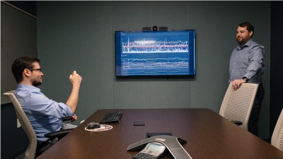 Photograph of a meeting between Alex Bakhtin on the left and Chris Dougherty on the right, discussing the performance of hardware and CPU usage in Langan's environments for both internal and external client applications.