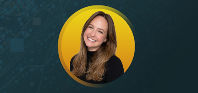 Portrait of Lauren Assyia smiling in a black turtleneck shirt