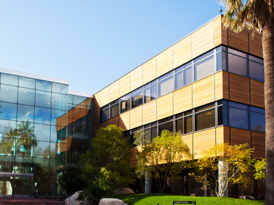 Esri’s Redlands headquarters building with walls of blue glass and wood and lush landscaping