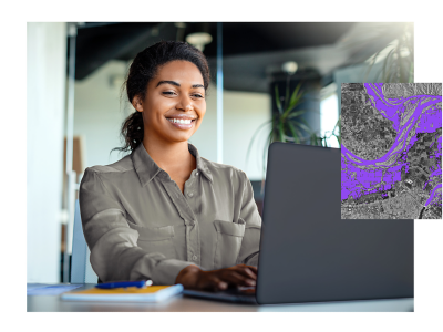 A woman smiling while using a laptop and a gray map with purple-shaded areas