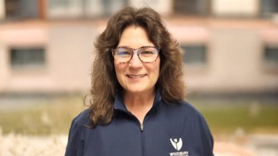 Retrato de Karen Steen sorrindo em um suéter azul com zíper