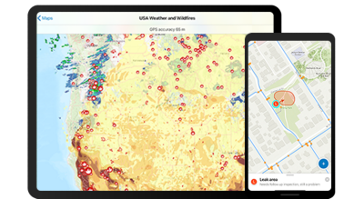 A tablet screen with a map of USA weather and wildfires next to a smart phone screen with a zoomed in view of an area