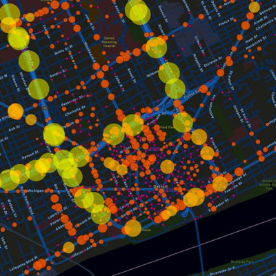 Dark basemap with streets displaying small orange circles, larger yellow circles, and bigger bright green circles that represent traffic density