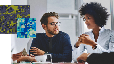 two gis professionals discuss maps at a meeting