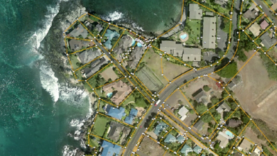 Aerial view of waterside community, with yellow lines outlining land parcels