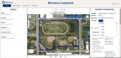 An aerial view of a school and athletic field, bordered by streets; property information is displayed on the right