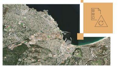 Satellite map of a city with green land and buildings in gray and a small image of a paper with check marks