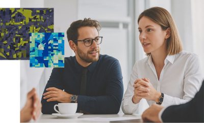two gis professionals discuss maps at a meeting