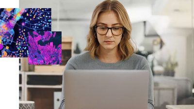a gis professional works on a map on a laptop