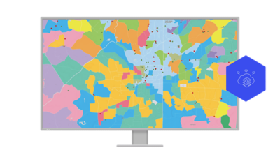 A computer monitor shows a colorful map of Atlanta, Georgia with each color representing a different geographic segment
