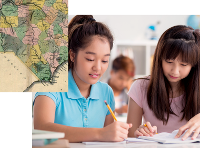 Two students sitting together, working on a school assignment