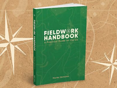 A physical copy of the Fieldwork Handbook with a green cover