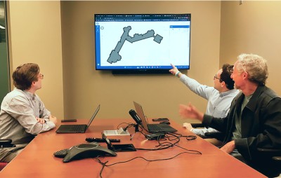 Ahaorn pointing at a map on a computer screen.