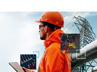 Kuvituskuva, missä on sähkötyöntekijä voimalinjan edessä.