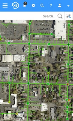 Aerial imagery with street grid and green lines indicating utility infrastructure
