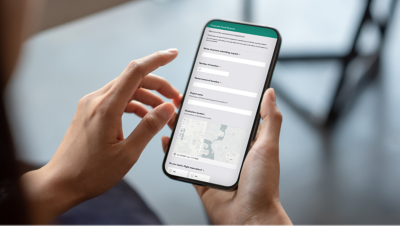 A person completing a form on their mobile device