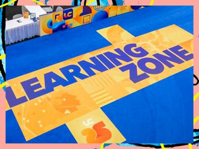 Vivid orange and blue event floor signage that says Learning Zone in bold text