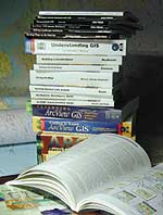 a stack of Esri Press books