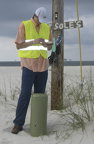 An undergraduate Auburn University student collecting location of utility in Fort Morgan, Alabama, using a Topcon GPS unit.