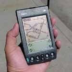 a palm pilot displaying a vehicle location on a street map.