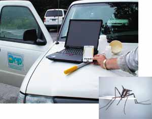 computer equipment and collection bottles set up on car hood to use ArcPad in the field