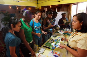Conference goers visit the Belize Natural Energy (BNE) booth.