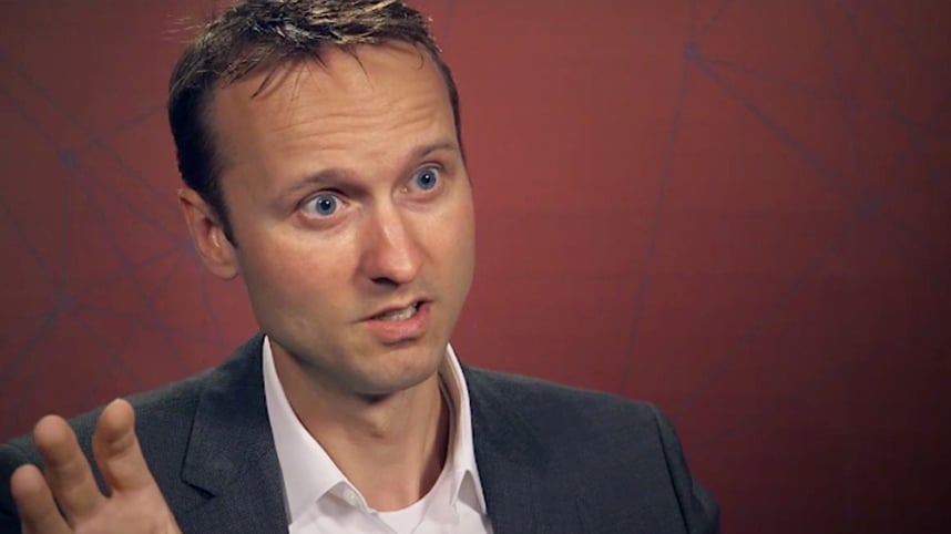 Man using GIS mapping software on smartphone at an earthquake disaster location